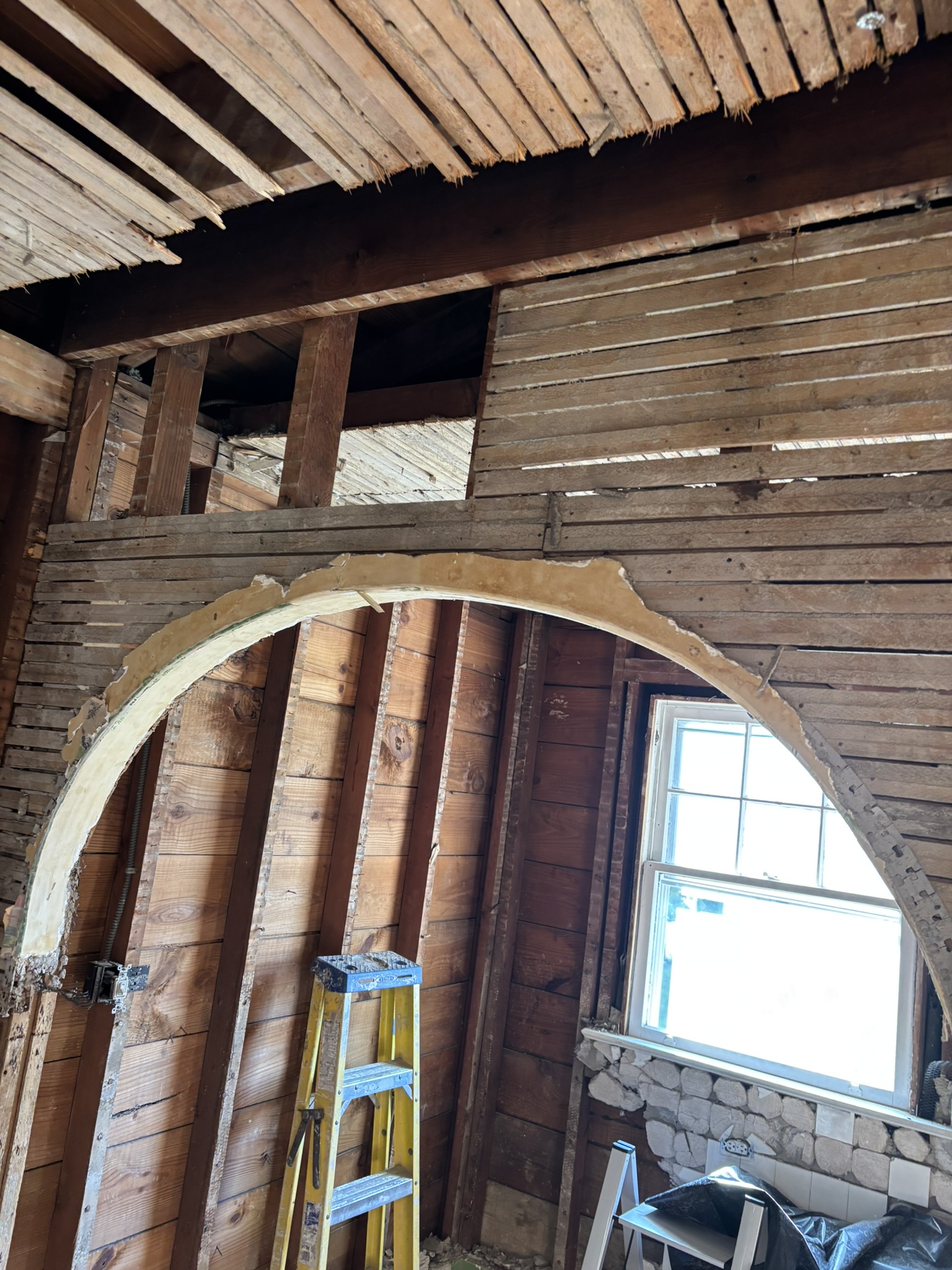 Exposing the interior framing and load-bearing wall during demolition—an essential first step before installing a professionally engineered support beam for an open-concept kitchen remodel.