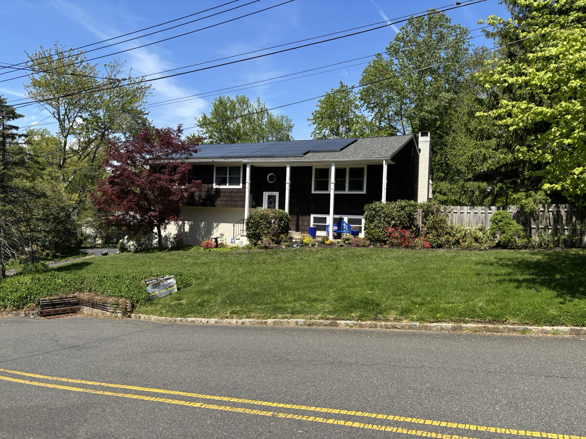 Front view of the Mountainside, NJ home featuring a solar-equipped roof—where structural evaluation revealed a sagging ridge beam and the need for engineered reinforcement to support added loads.