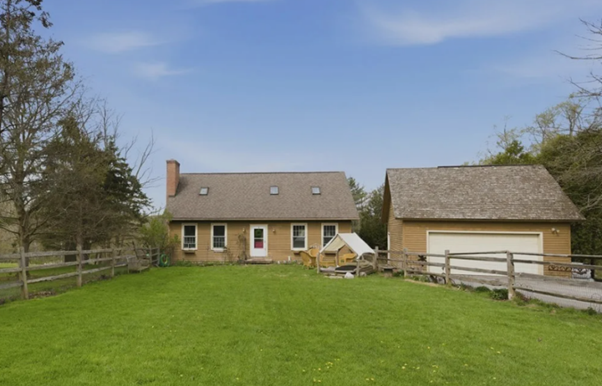 Front view of a single-family home in Cazenovia, NY, situated on a sloping lot—an important factor contributing to observed foundation settlement.
