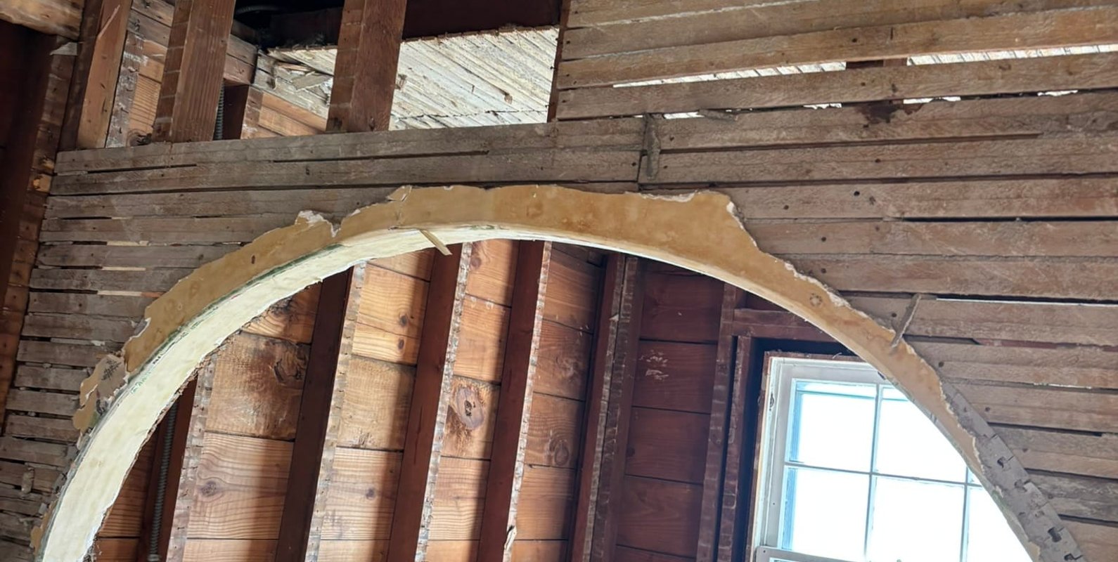 Exposing the interior framing and load-bearing wall during demolition—an essential first step before installing a professionally engineered support beam for an open-concept kitchen remodel.