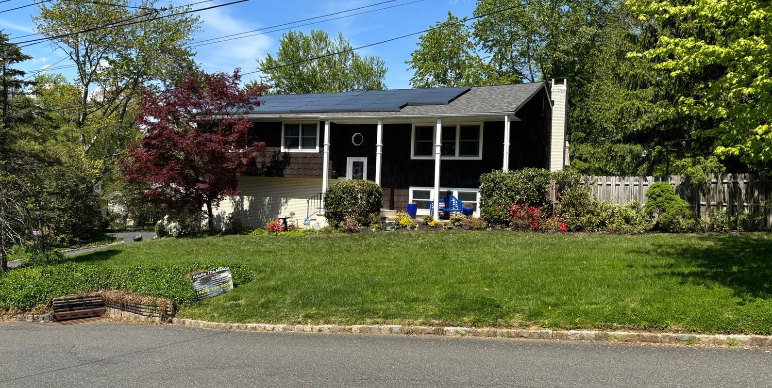 Front view of the Mountainside, NJ home featuring a solar-equipped roof—where structural evaluation revealed a sagging ridge beam and the need for engineered reinforcement to support added loads.