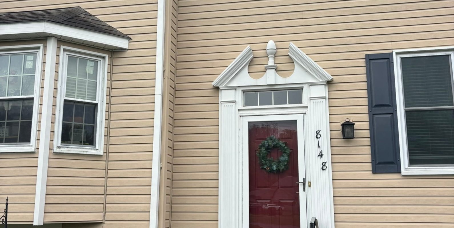 Exterior view of a residential townhouse where customer had cracks forming at edge of ceiling, windows, and walls —common signs homeowners and buyers should inspect after a hard winter due to potential structural movement.