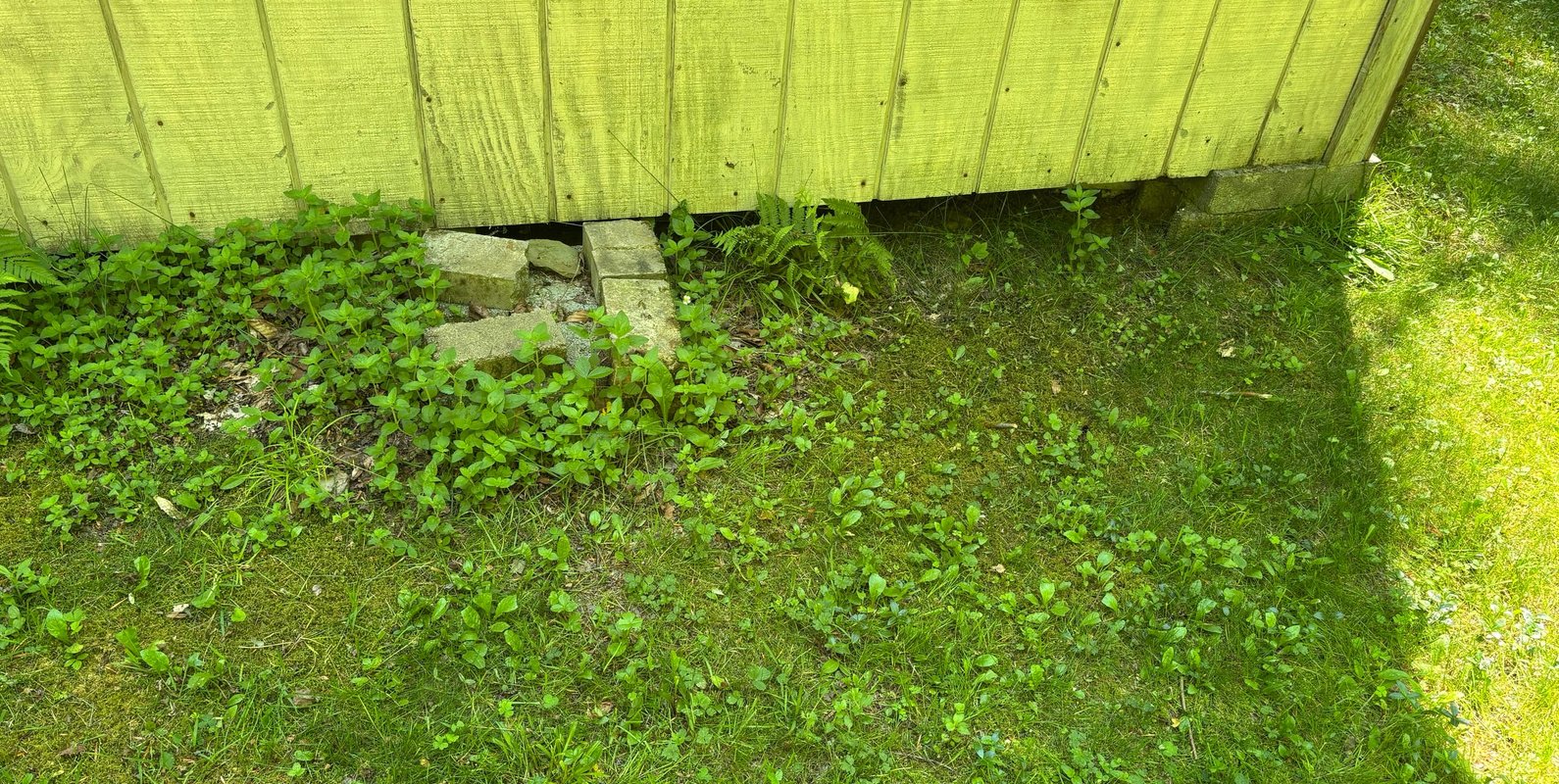 Existing foundation supported on loosely stacked concrete masonry units. Updated snow load requirements and planned renovations required a new engineered foundation system.