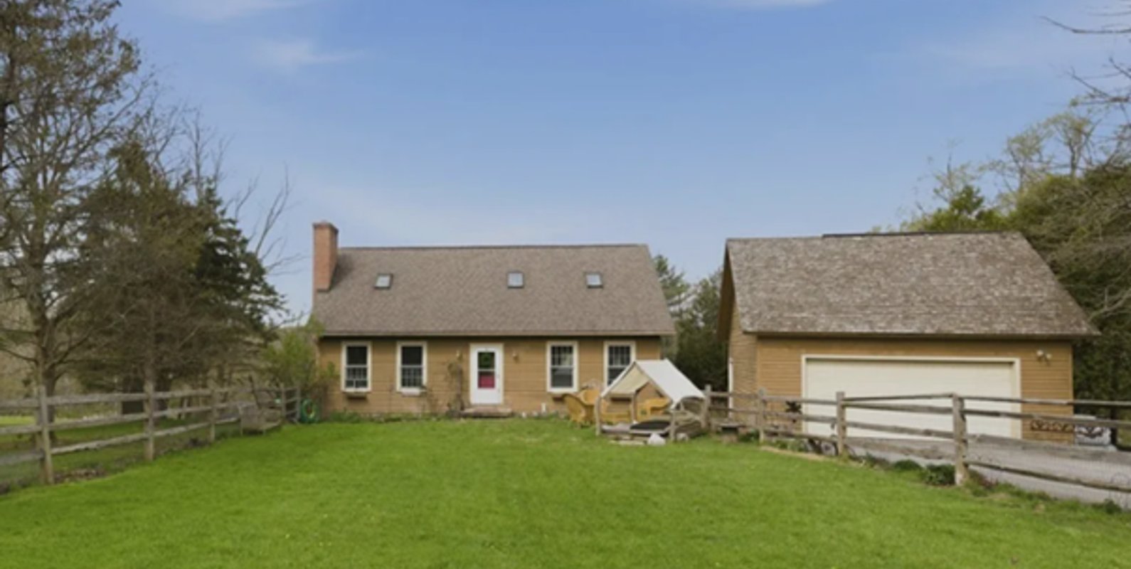 Front view of a single-family home in Cazenovia, NY, situated on a sloping lot—an important factor contributing to observed foundation settlement.