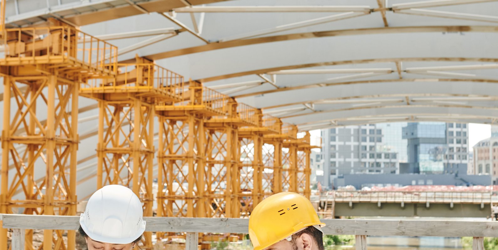 An architect and structural engineer reviewing construction plans on site—illustrating the importance of coordinated architectural and structural design.