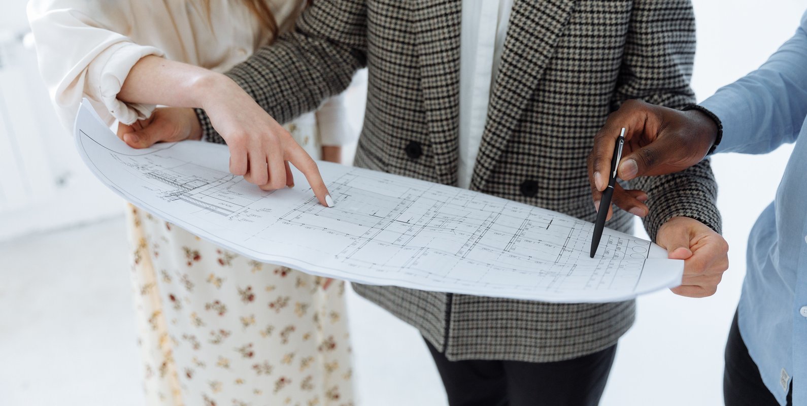 Architect and structural engineer reviewing residential house plans and structural drawings for a home construction project.