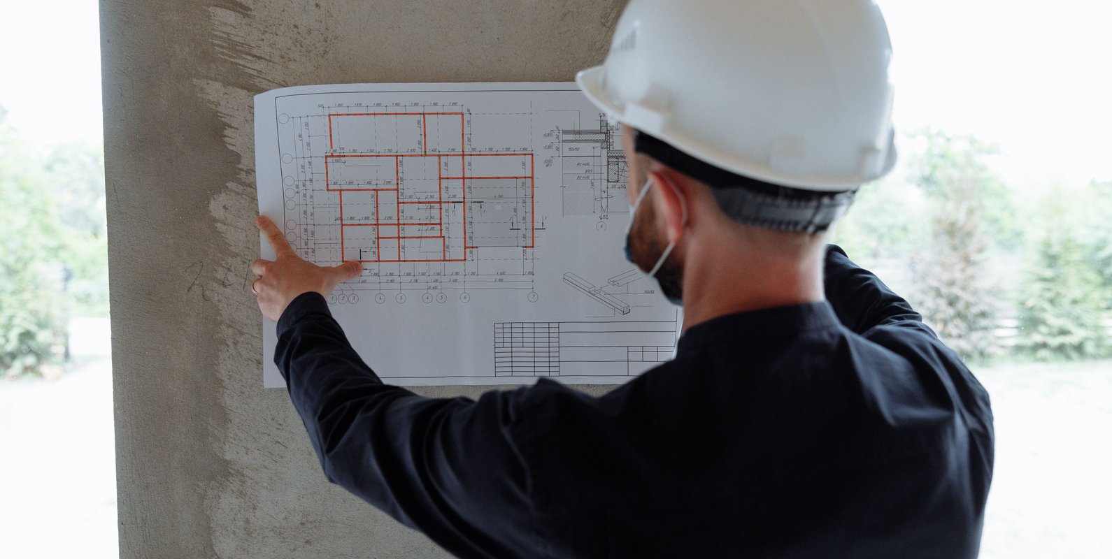 An architect reviews residential building plans, highlighting the importance of collaboration between architectural design and structural engineering for safe, functional, and well-planned homes.