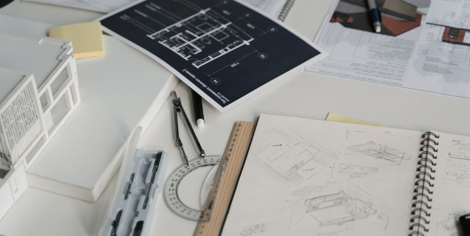 Building designer and residential architect working together to develop coordinated home design and structural plans.