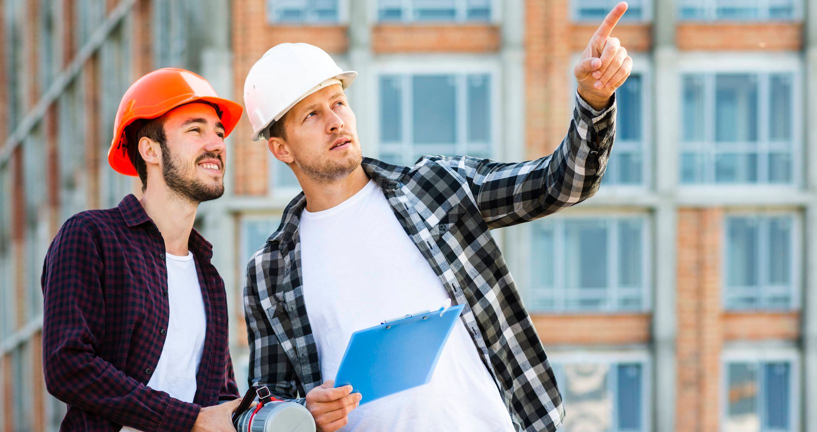 construction workers looking at blueprints